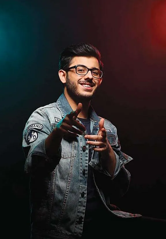 a man wearing glasses and a denim jacket