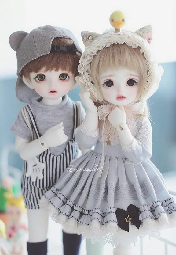 a couple of dolls standing next to each other