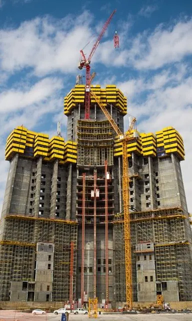 a large building under construction with a crane on top of it