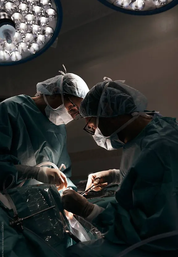 two surgeons performing surgery in an operating room