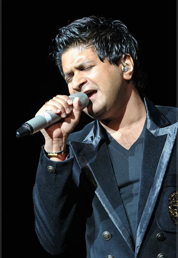 a man in a suit singing into a microphone