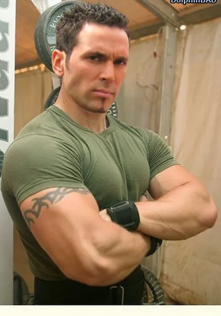 a man in a green shirt with his arms crossed