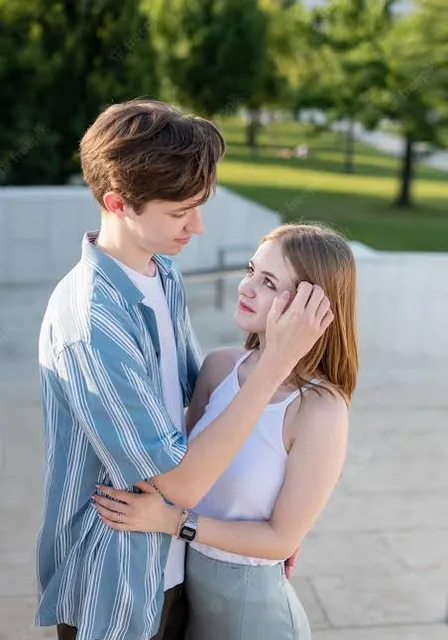 a boy and a girl standing next to each other