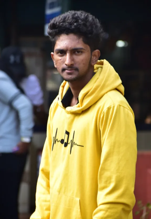 A man in a yellow hoodie stands in front of a building in 3d effects. 3d effects