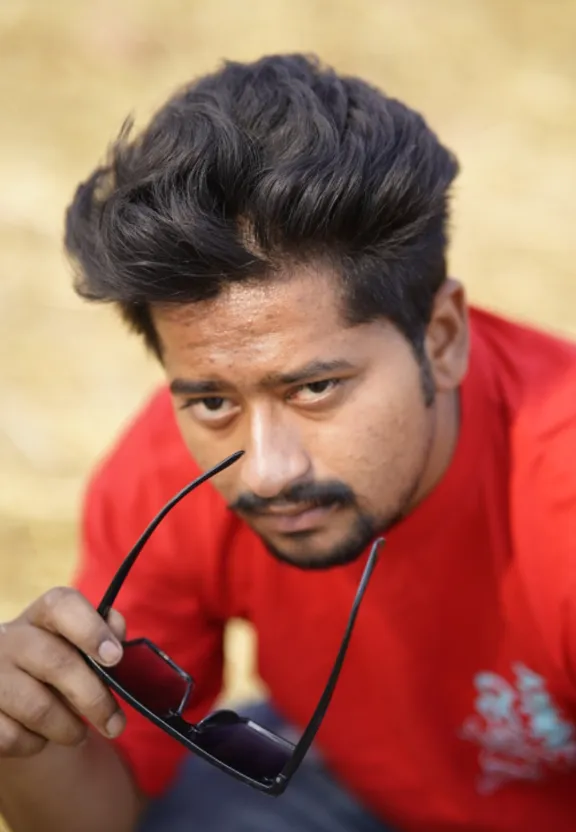 a man with a moustache holding a cell phone