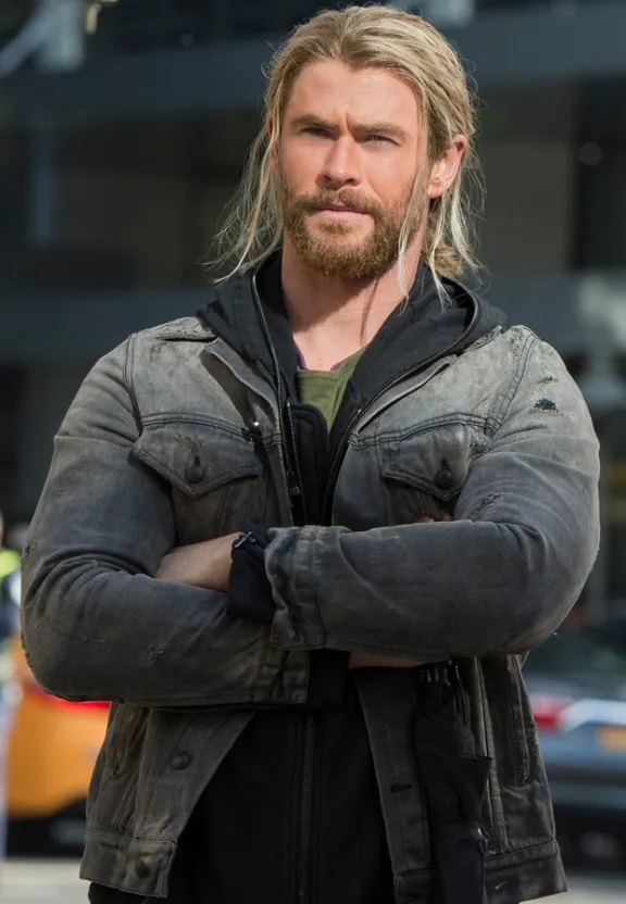 a man with long hair and a beard wearing a jacket