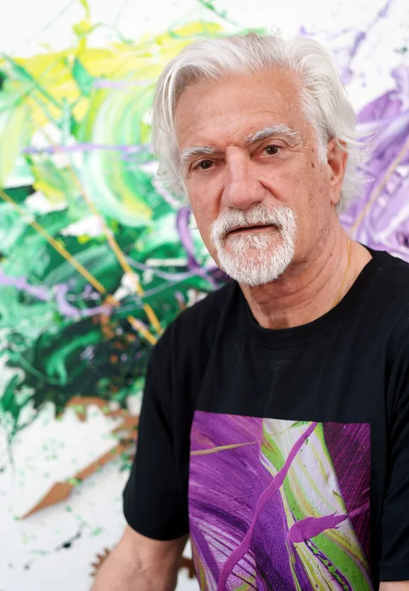 a man with white hair and a black shirt