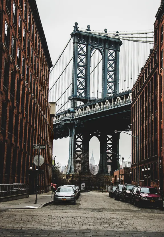 a large bridge spanning over a city street