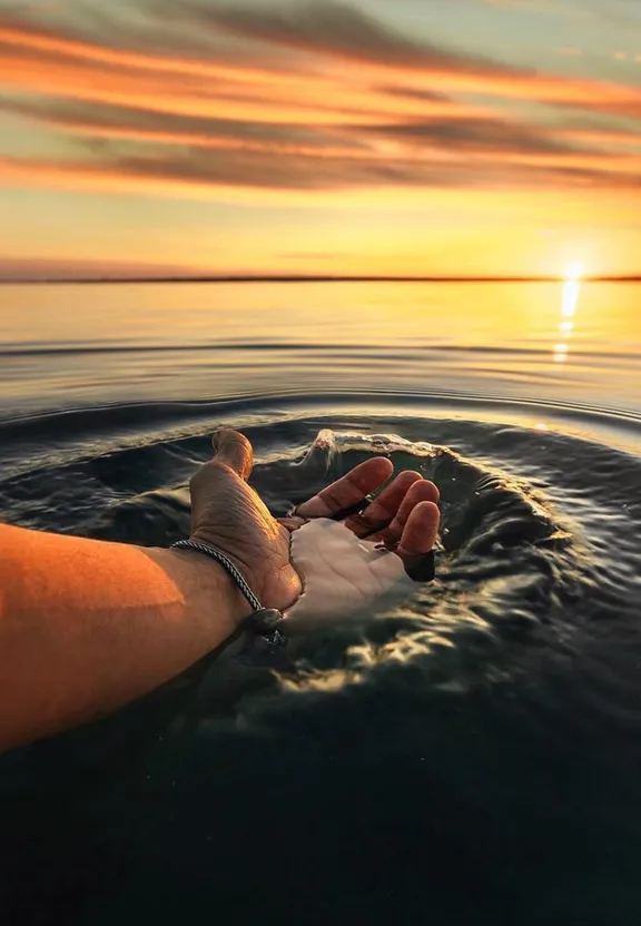 a person laying on top of a surfboard in the ocean