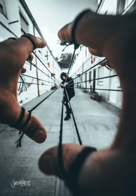 a person holding a bicycle wheel in their hands