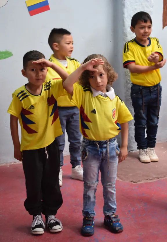 a group of young children standing next to each other