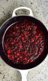 a pan filled with cranberry sauce on top of a counter