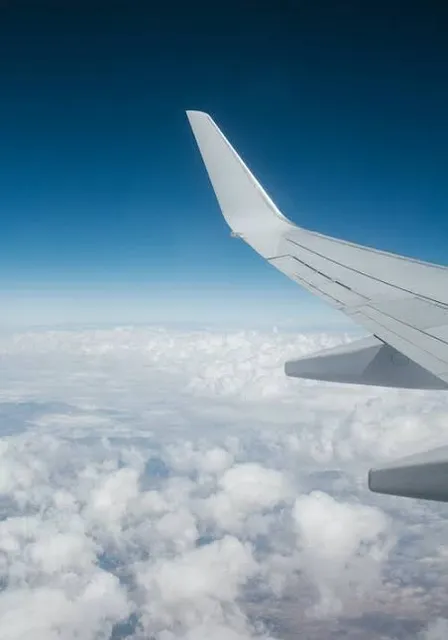 the wing of an airplane flying above the clouds