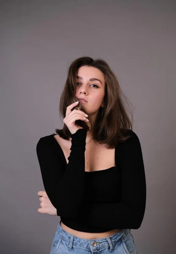 a woman in a black top smoking a cigarette