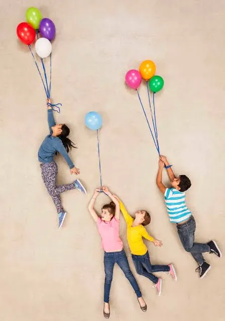 a group of people holding balloons in the air