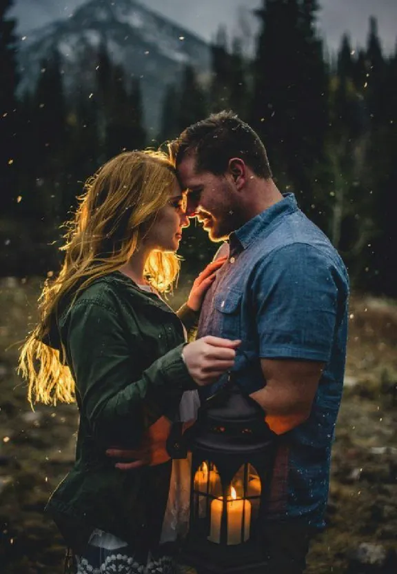 a man and a woman standing next to each other holding a lantern