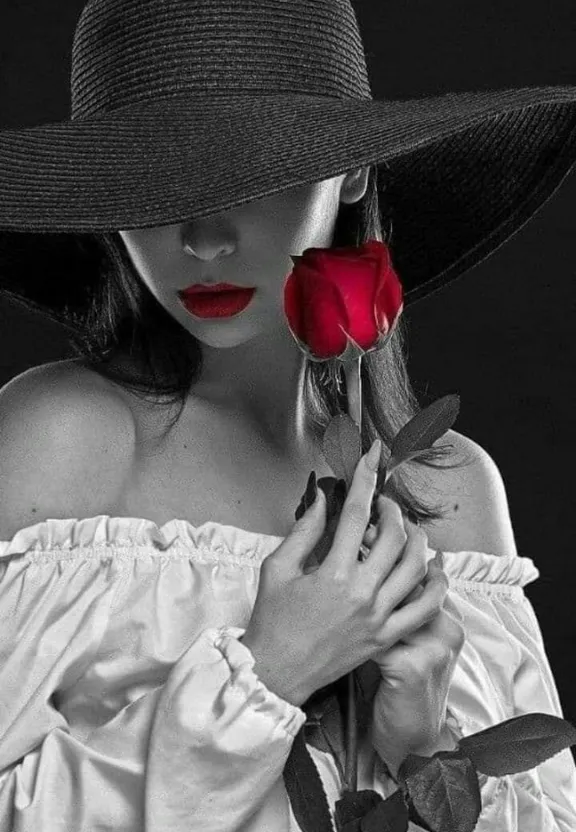 a woman wearing a hat and holding a rose