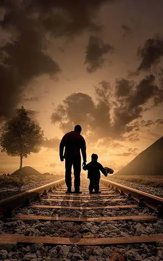 a man and a child standing on a train track