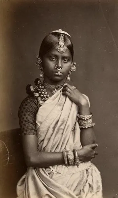 an old photo of a woman in a sari