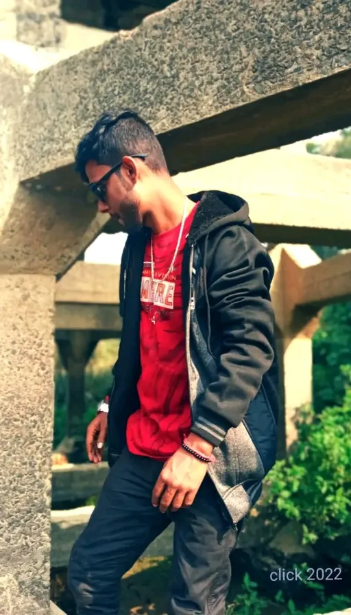 a man standing in front of a stone structure