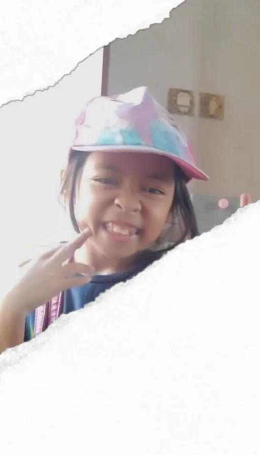 a little girl wearing a hat and smiling