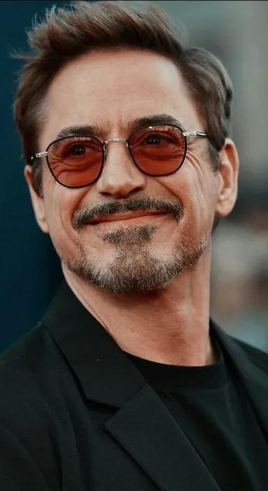 a close up of a person wearing glasses