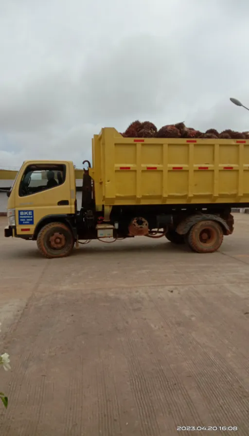 a yellow dump truck parked in a parking lot