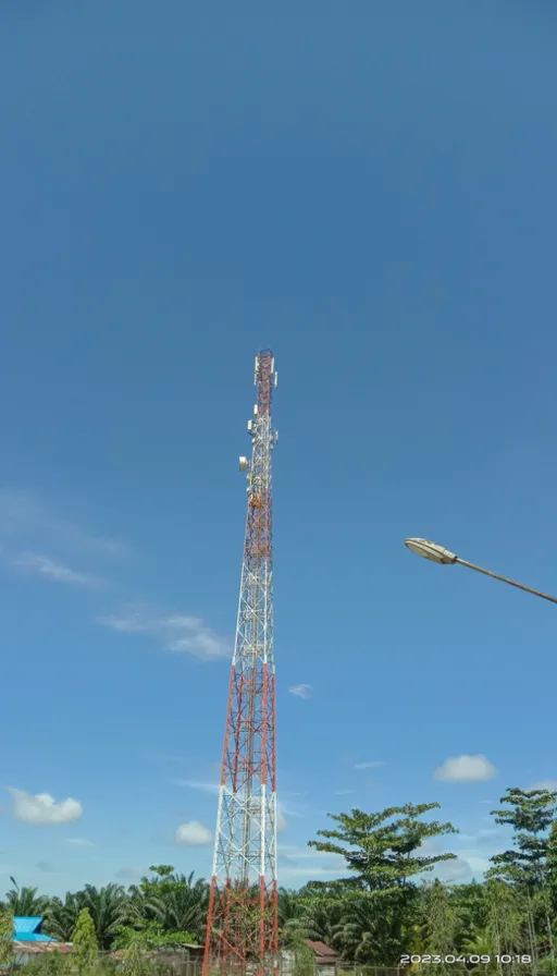 a very tall tower sitting in the middle of a field