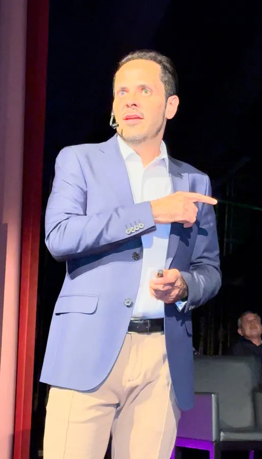 a man in a blue suit pointing at something