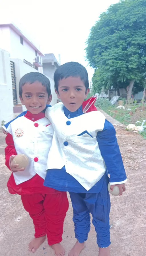 two young boys dressed in traditional indian clothing