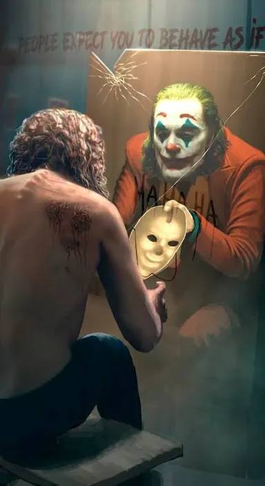 a man sitting in front of a painting of a joker