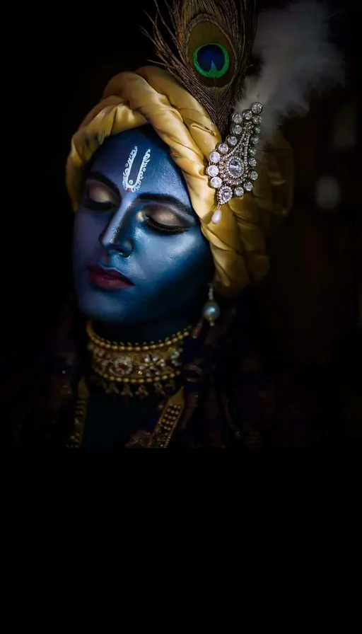 a woman with blue face paint and a peacock feather on her head