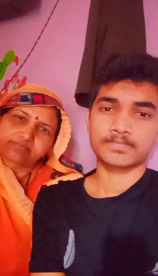 a man and a woman taking a selfie in front of a mirror