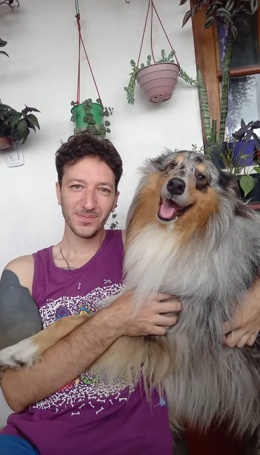 a man holding a dog in his arms