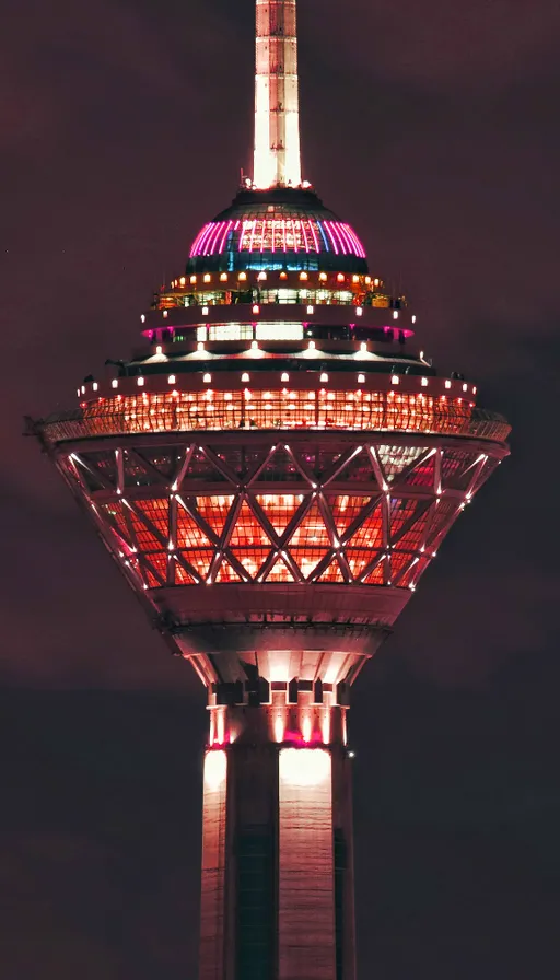 a very tall tower with a lit up top