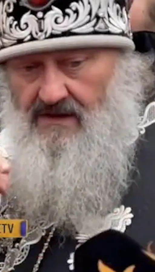 a man with a beard wearing a crown