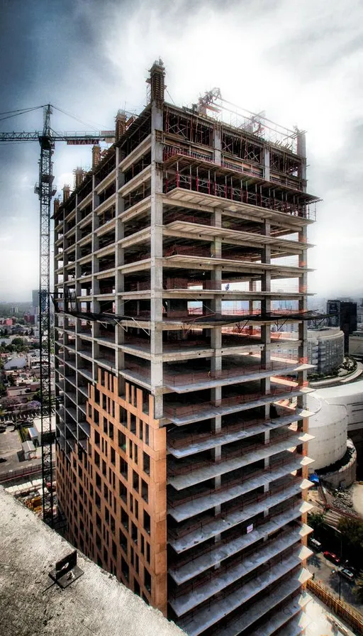 a tall building with lots of scaffolding on top of it