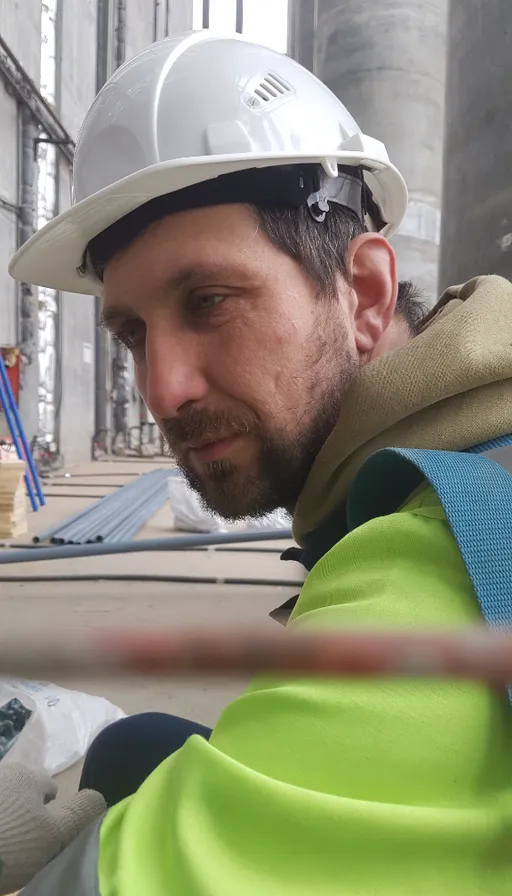 a man wearing a hard hat and safety gear