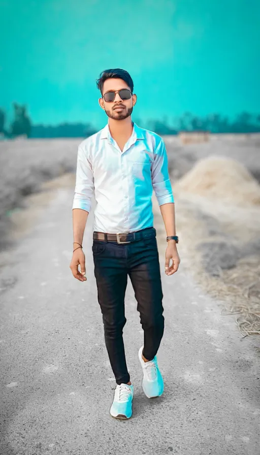 a man in a white shirt and black pants walking down a road