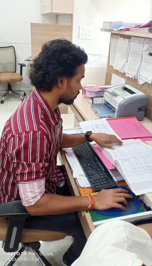 a man sitting at a desk working on a computer