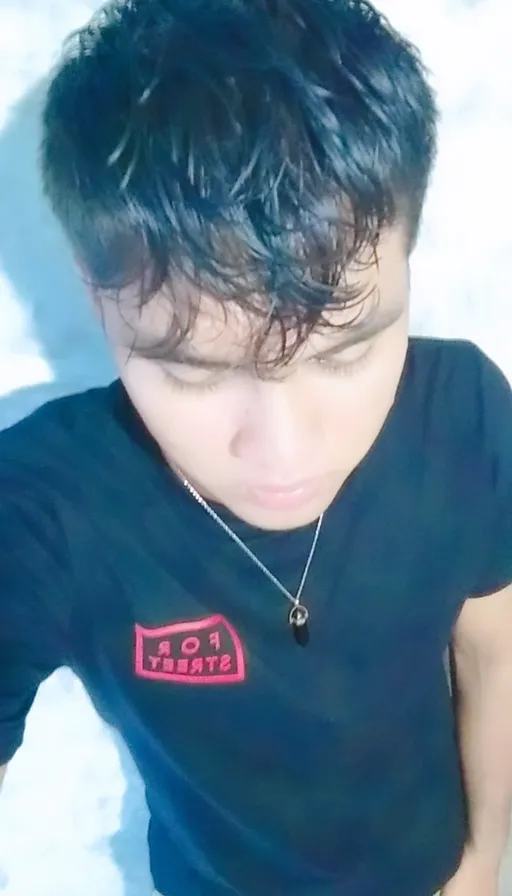 a man with black hair wearing a black shirt