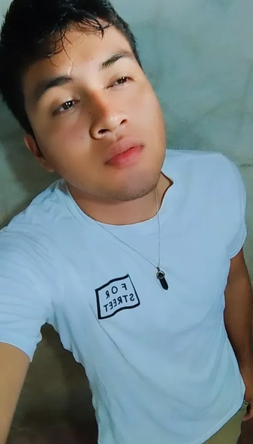 a man in a blue shirt posing for a picture