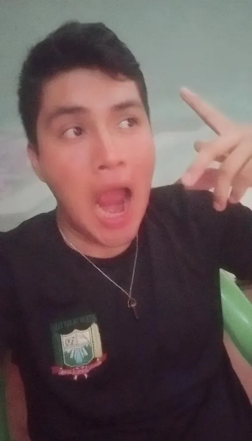 a young man making a funny face with his fingers