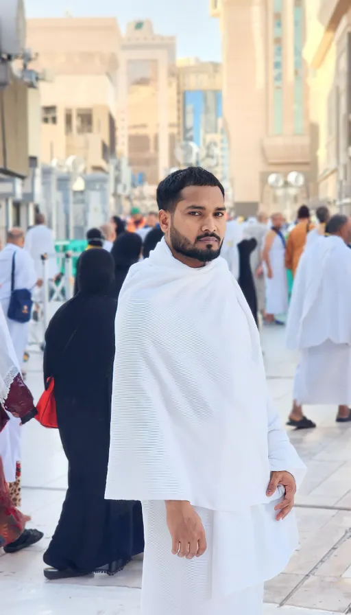 a man in a white outfit standing on a street