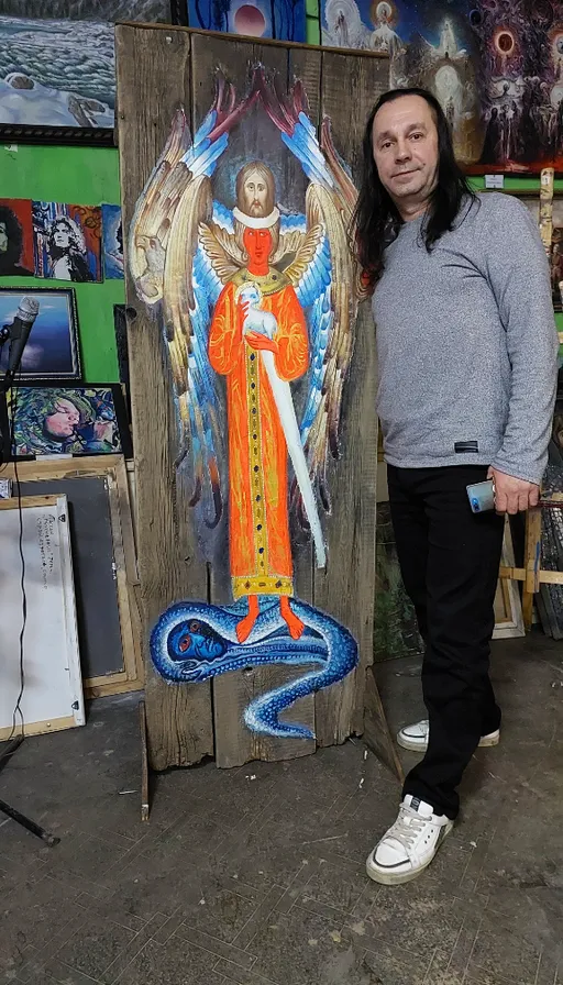 a man standing next to a painting of an angel