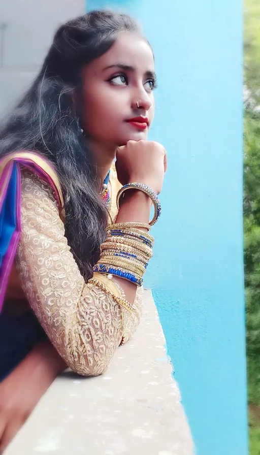 a woman with long hair wearing a colorful sari