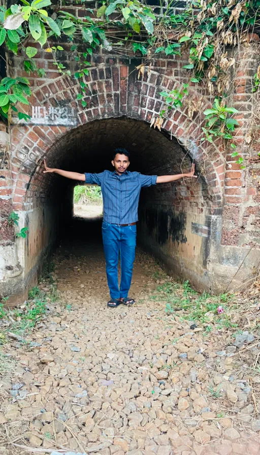 A man standing in a tunnel with his arms outstretched. make the tunnel smaller