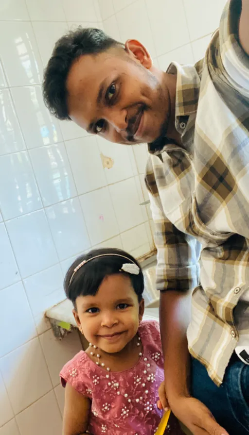 a man standing next to a little girl in a bathroom