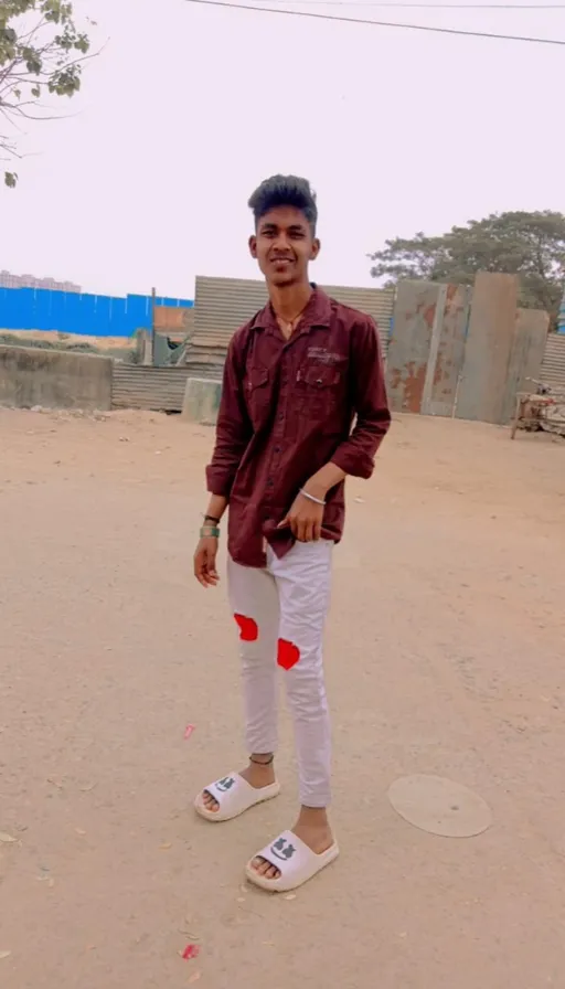 a man standing in the middle of a dirt road