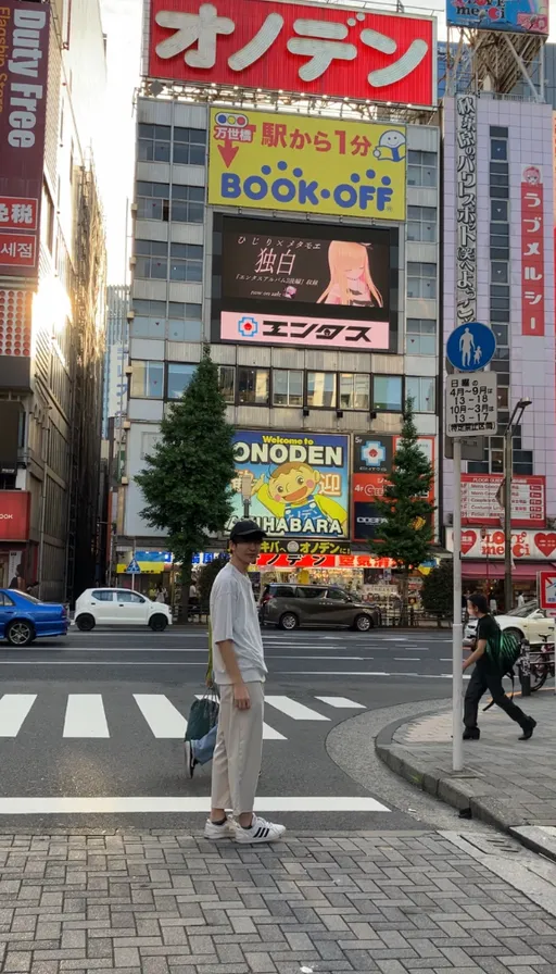 a man walking across a crosswalk in a city, blurred so it's unclear where he is. blur the background, making it unclear where the man is walking